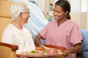caregiver preparing meal for her patient